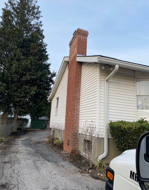 ChimneySaver vapor-permeable waterproofing on a stone Maryland chimney with 10-year warranty
